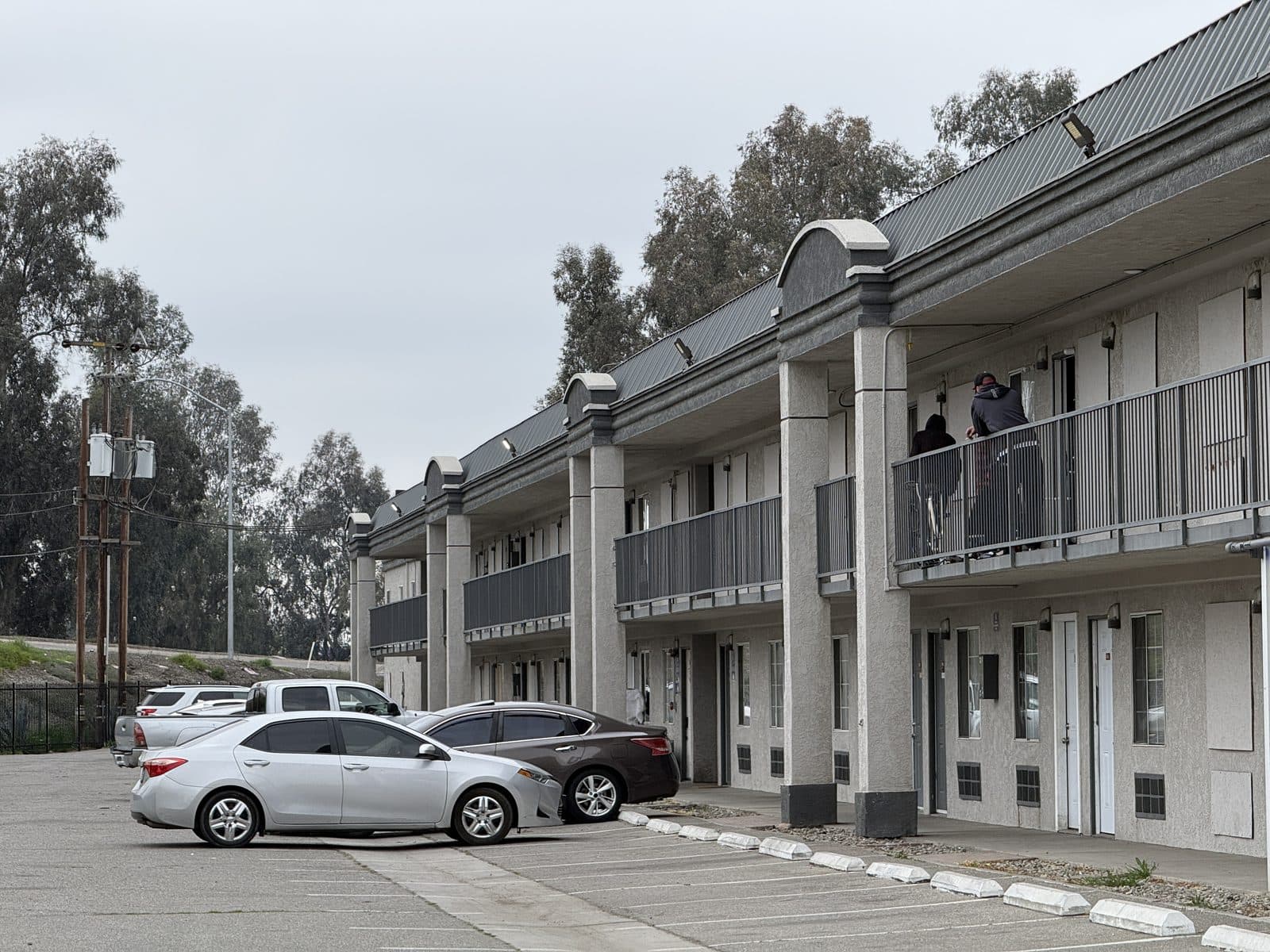 Street-facing two-story studio buildings with surface parking